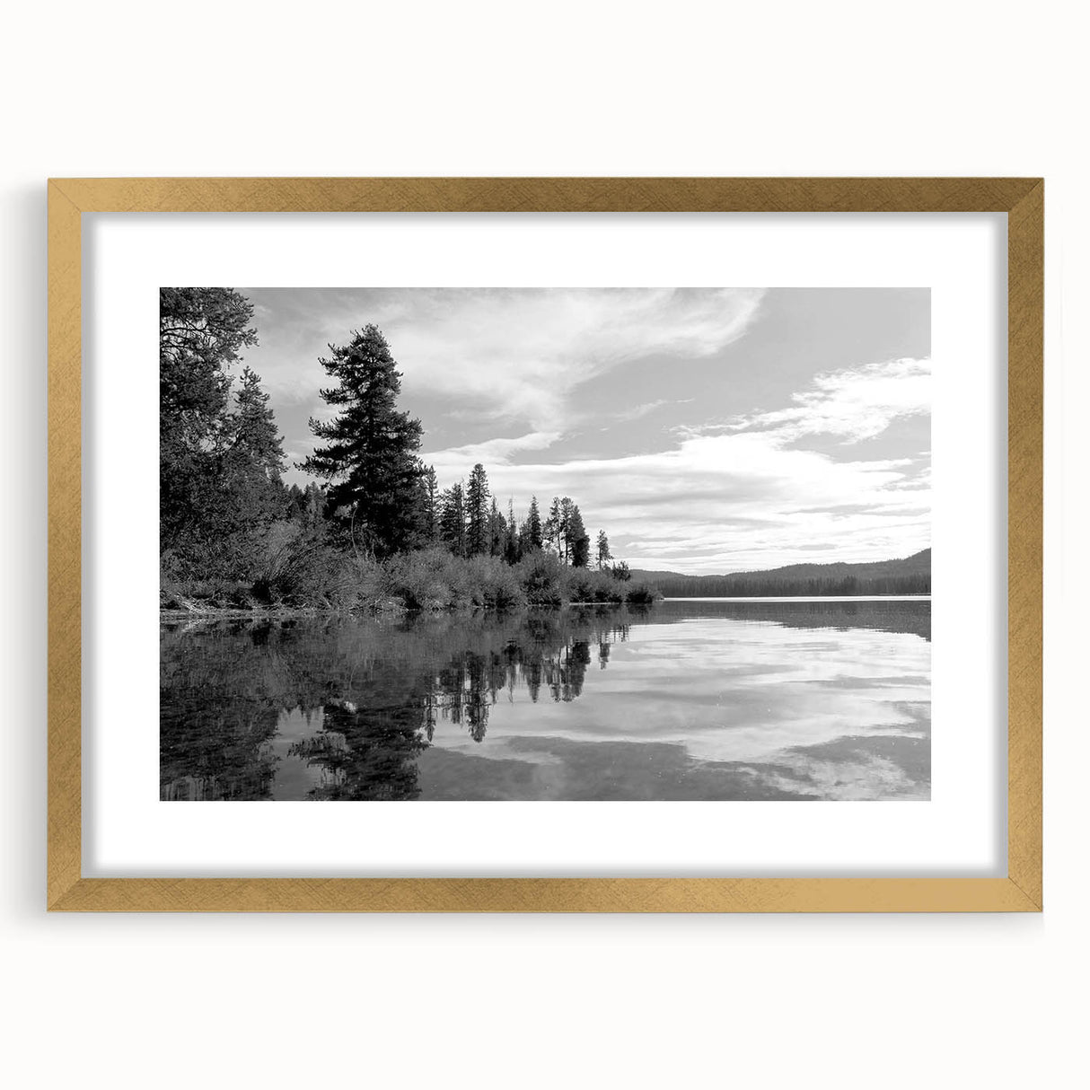 Framed wall art of a serene countryside landscape, featuring lush green fields and a blue sky, elegantly displayed with a gold mat, perfect for home decor.