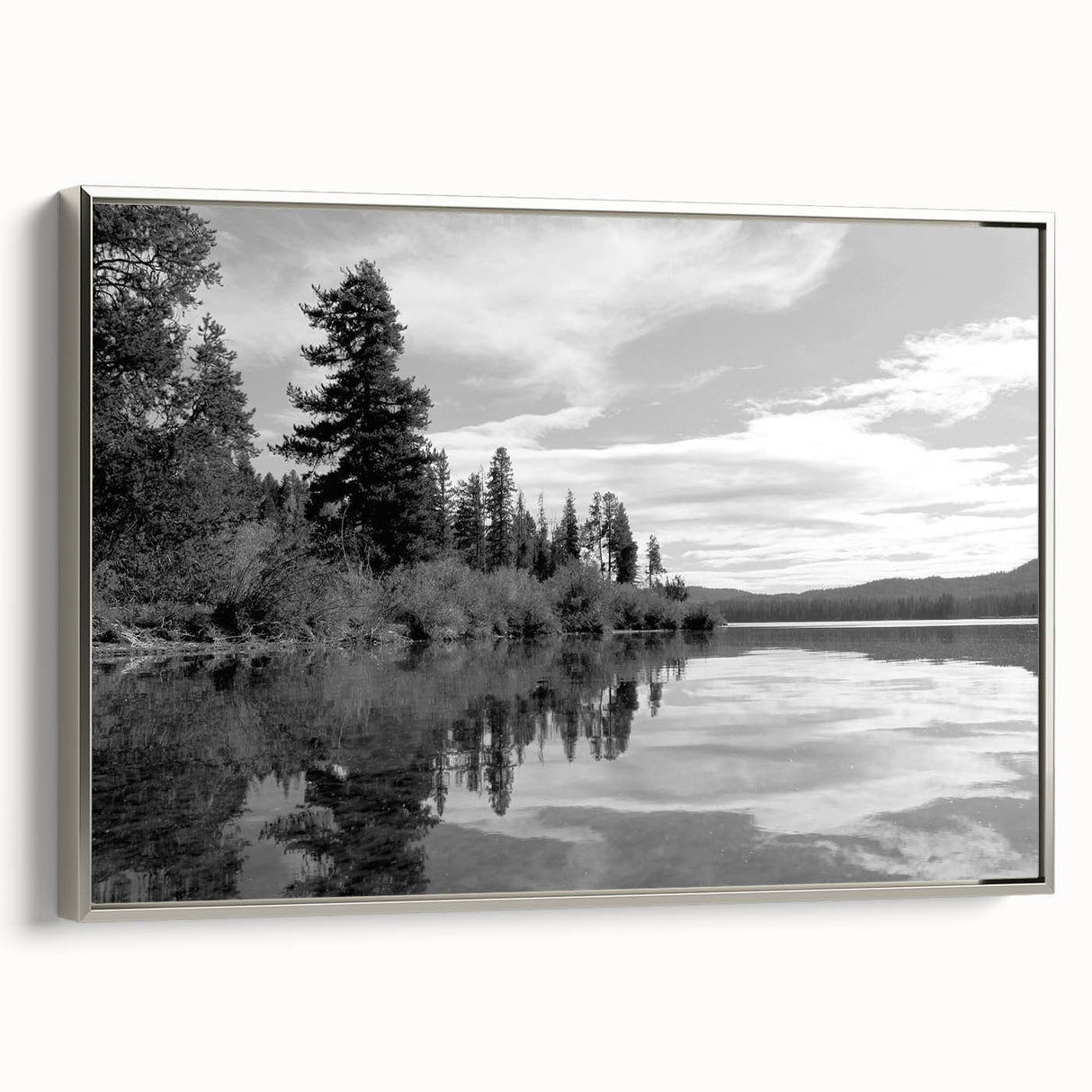 Framed canvas wall art showcasing a picturesque countryside landscape design, featuring vibrant green fields and a serene blue sky, elegantly displayed with a silver frame.