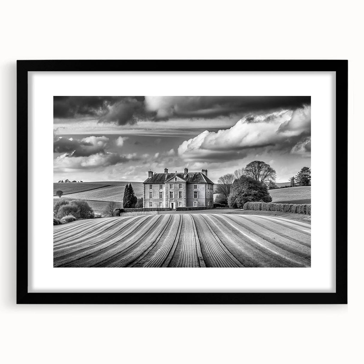 Framed wall art showcasing a serene countryside landscape with vibrant green fields and a striking blue sky. The black frame enhances the artwork's elegance, making it a perfect home decor piece.