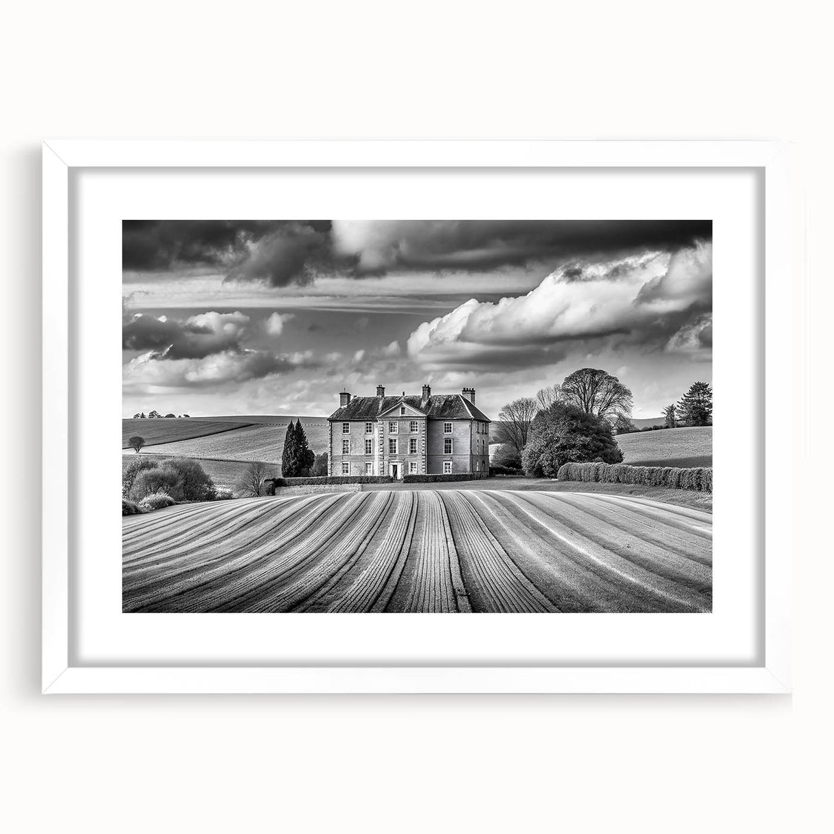 Framed wall art print featuring a serene countryside landscape, showcasing rolling hills and a vibrant sunset, presented in a white mat for an elegant display.