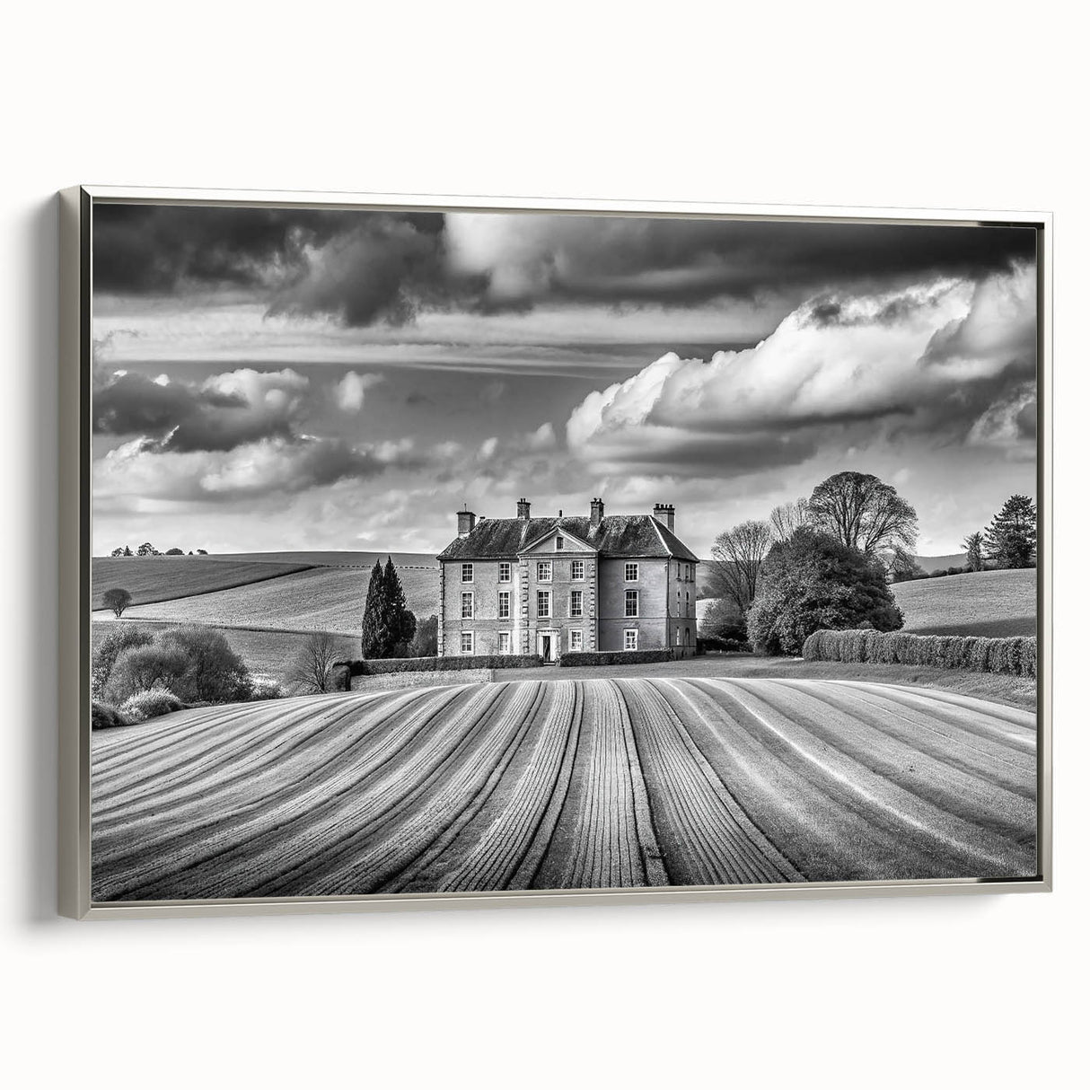 Framed wall art showcasing a serene countryside landscape with vibrant greens and blues, accented by a sleek silver frame, ideal for home decor.