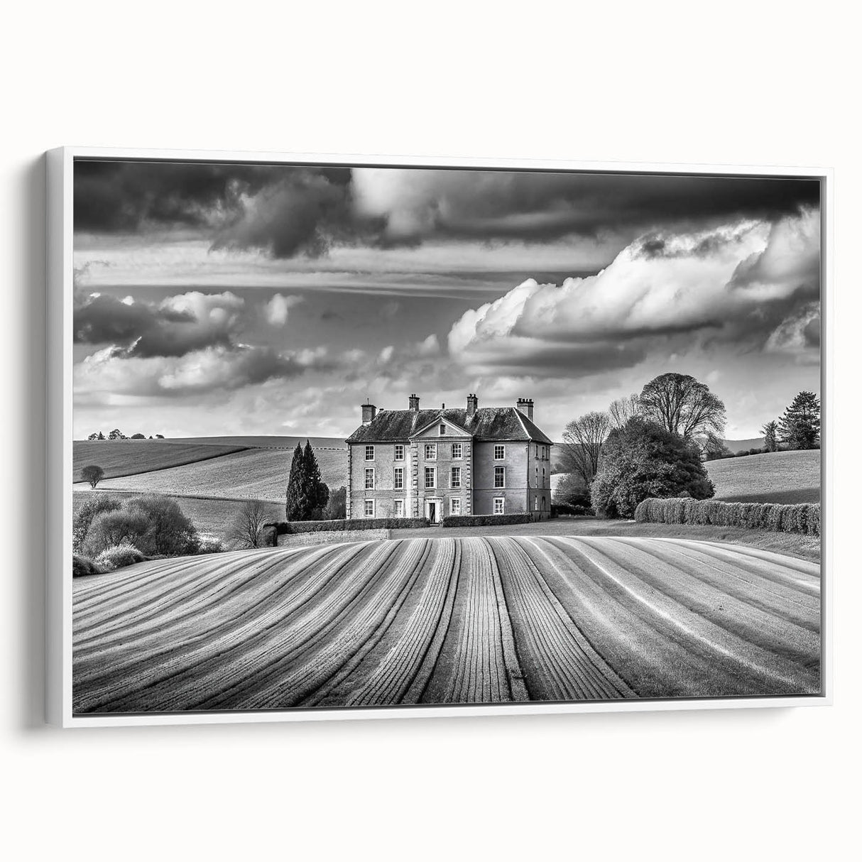 Framed canvas wall art showcasing a serene countryside landscape design with lush green fields and a bright blue sky, perfect for home decor.