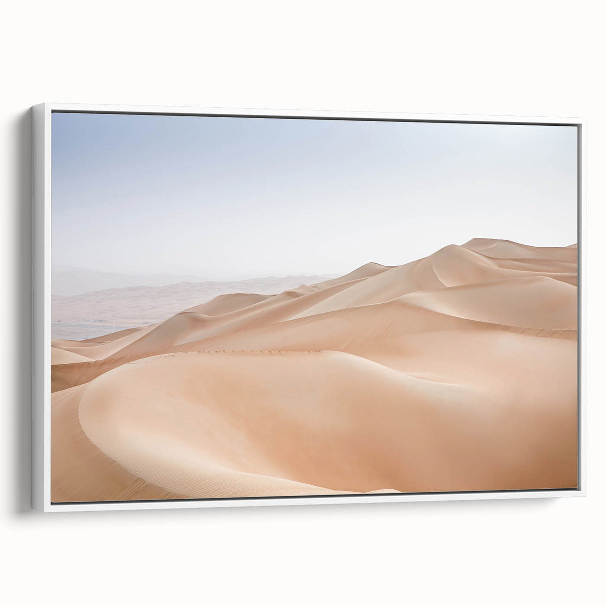 Framed canvas wall art showcasing a vibrant desert landscape design with warm hues of orange and yellow, set against a white frame, ideal for modern home decor.