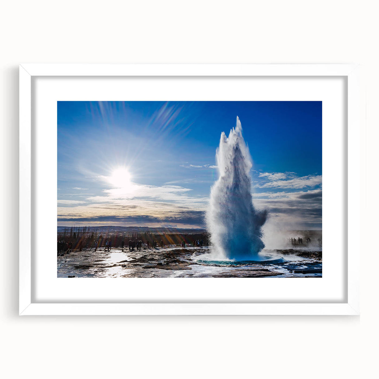 Framed wall art featuring a serene landscape with a geyser, set against a white mat, perfect for enhancing home decor. Ideal for nature enthusiasts and modern interiors.