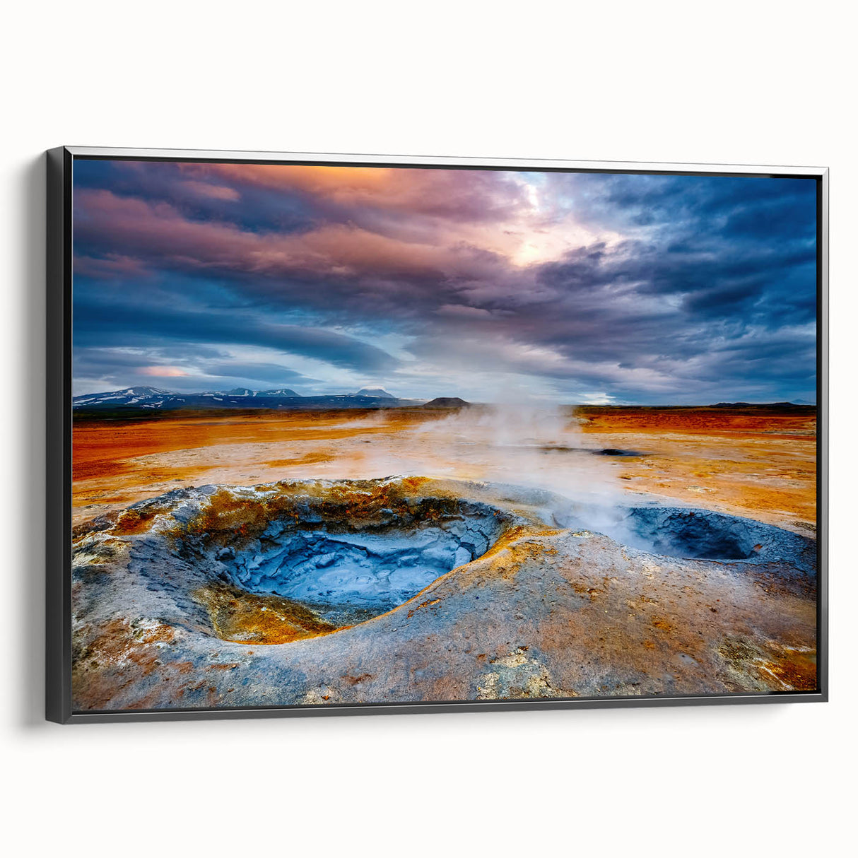 Framed wall art piece showcasing a stunning geyser landscape design in vibrant colors, featuring a sleek black frame, ideal for enhancing modern home decor.