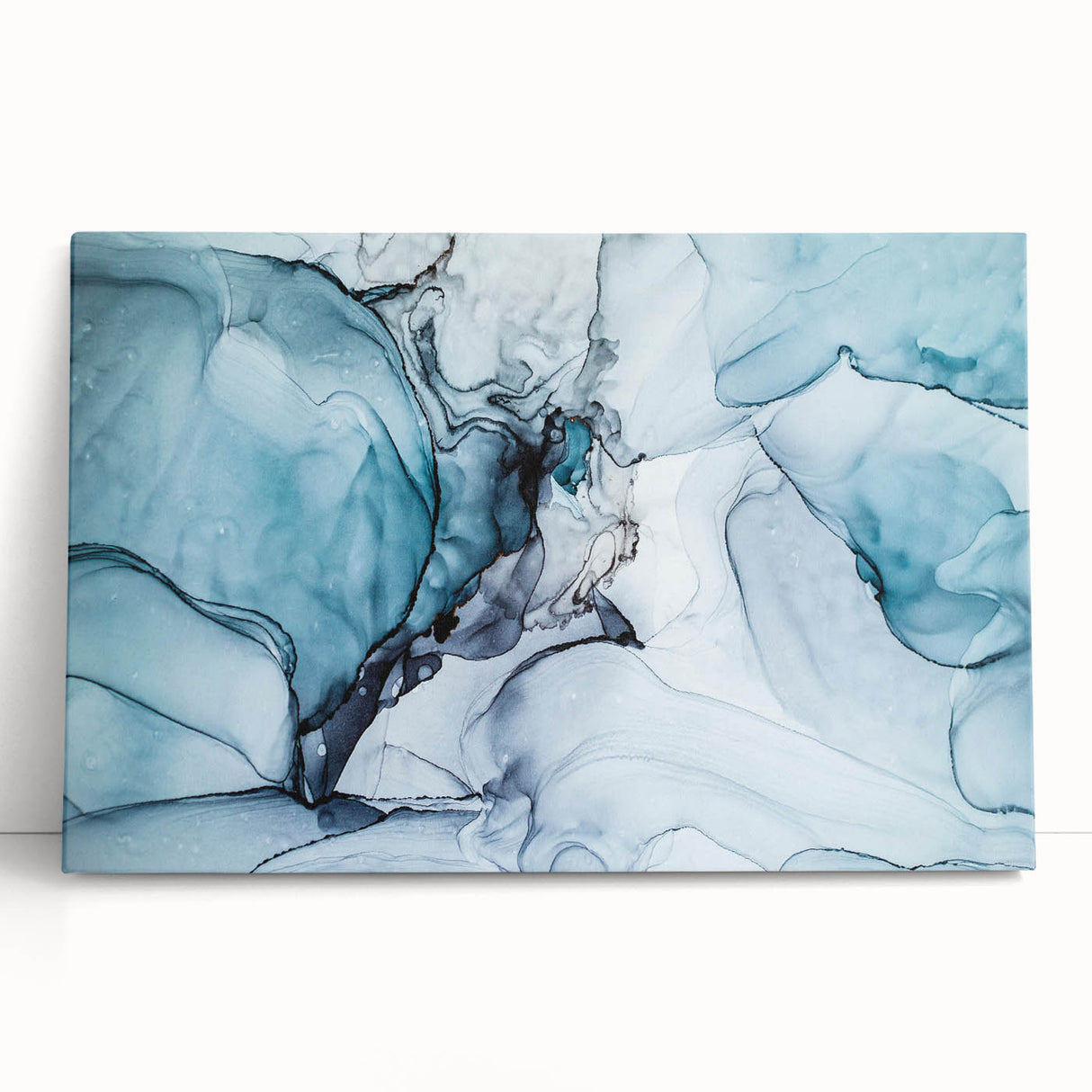 Stretched canvas wall art showcasing a stunning glacier landscape design with vibrant blues and whites, leaning against a neutral wall, perfect for home decor.