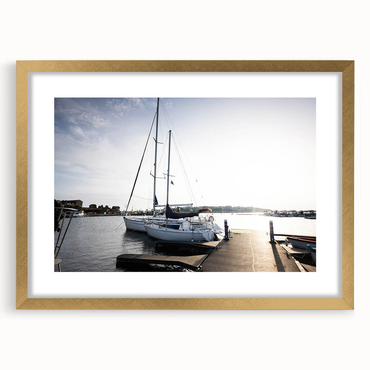 Framed wall art collection showcasing a serene harbor landscape with vibrant colors, featuring a gold mat and frame, perfect for home decor enhancement.
