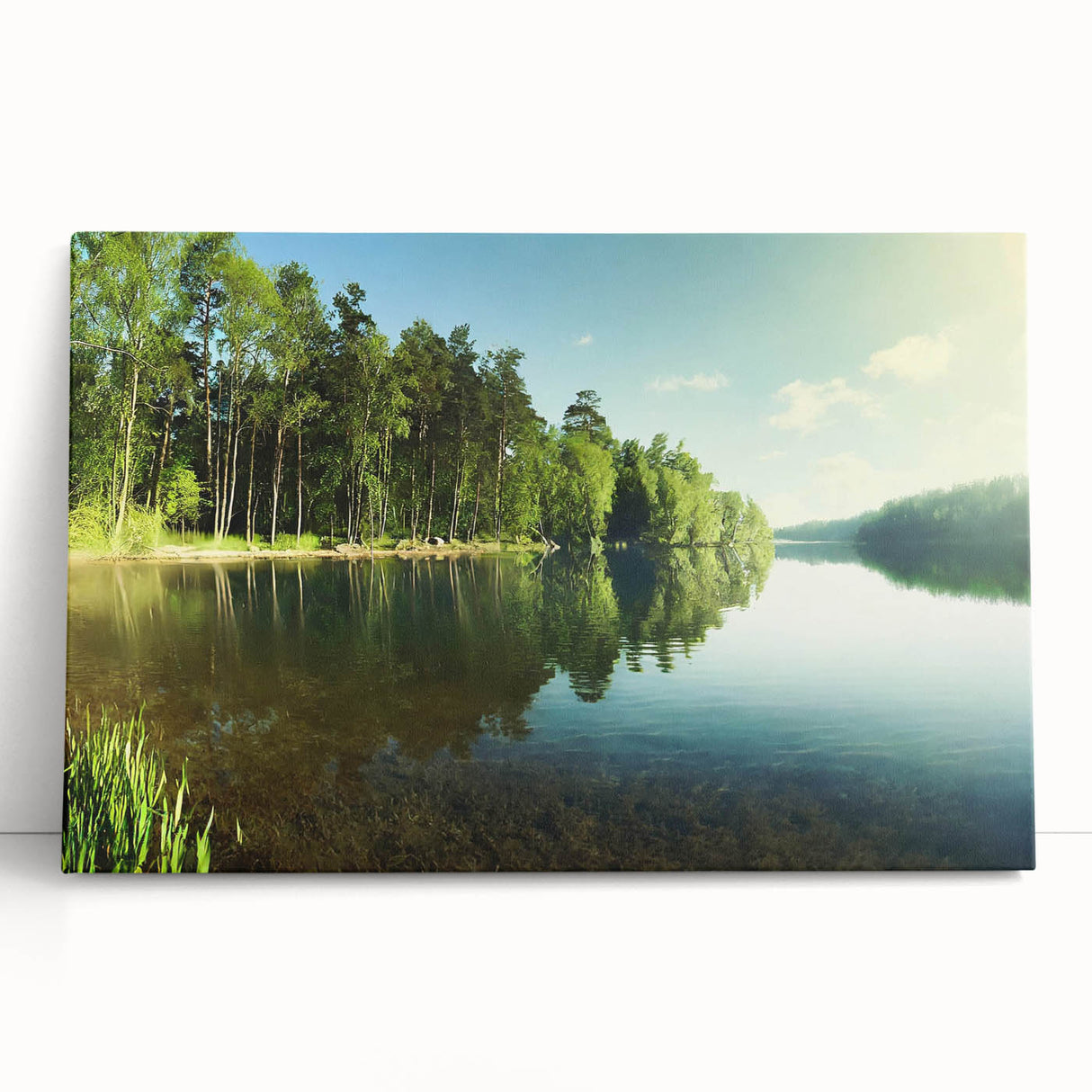 Stretched canvas artwork showcasing a serene lakeside landscape, with vibrant colors reflecting in the water, perfect for home decor or office ambiance.