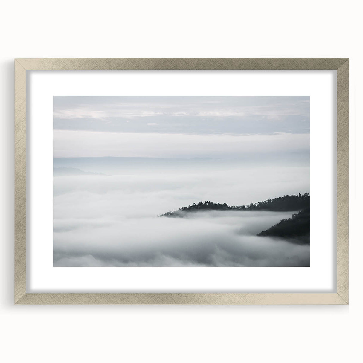 Framed wall art featuring a serene landscape design with mist and fog, presented in a stylish silver frame with a mat, ideal for enhancing home decor.