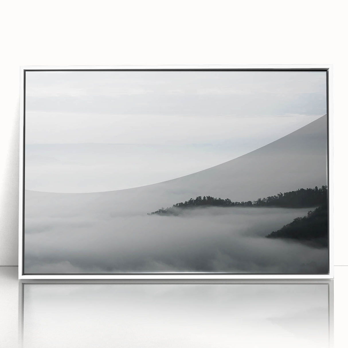 Framed wall art depicting a serene landscape shrouded in mist, featuring soft gray and white tones with a sleek white frame, perfect for home decor.