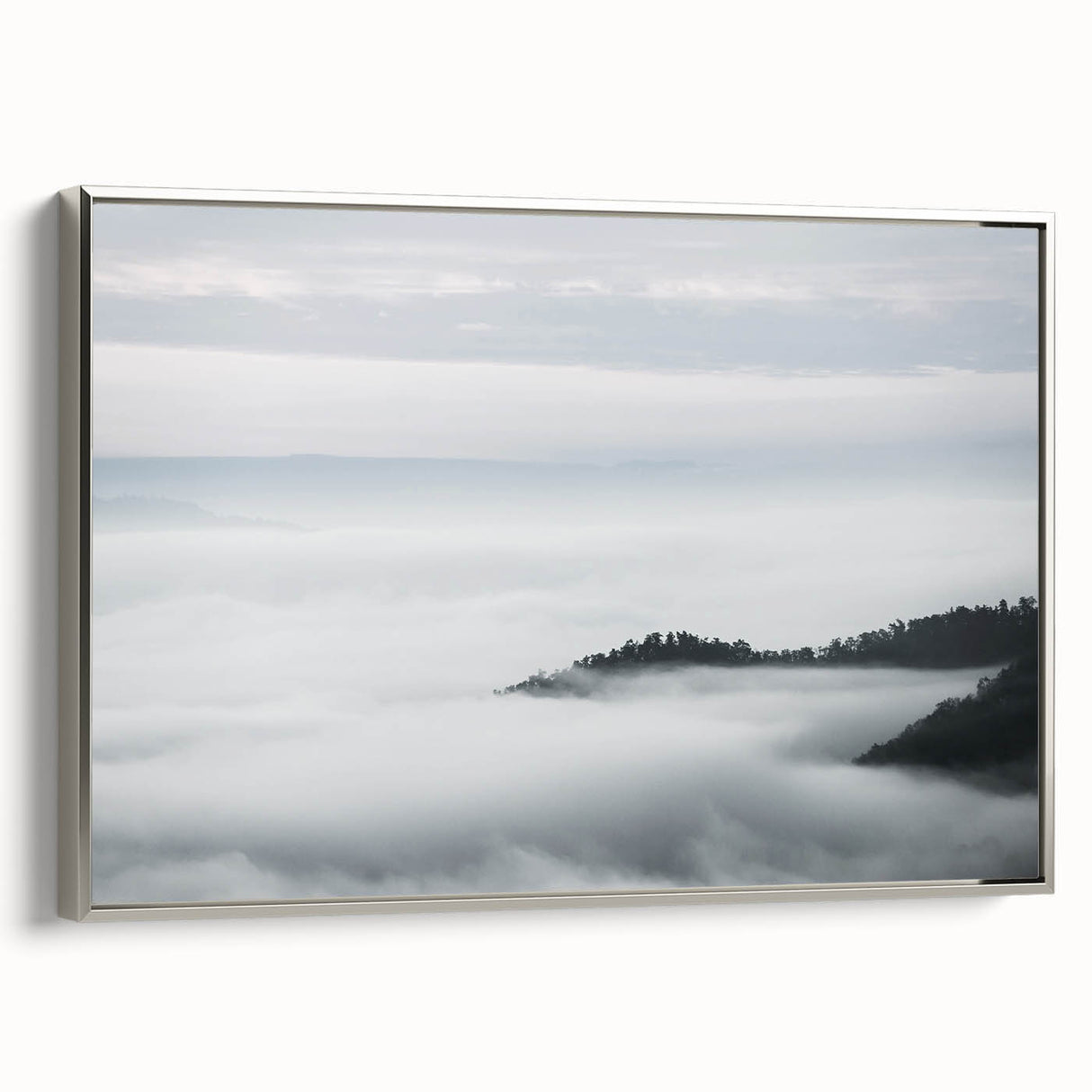 Framed canvas wall art featuring a serene landscape design with mist and fog, showcasing soft gray and silver tones, perfect for home decor enhancement.