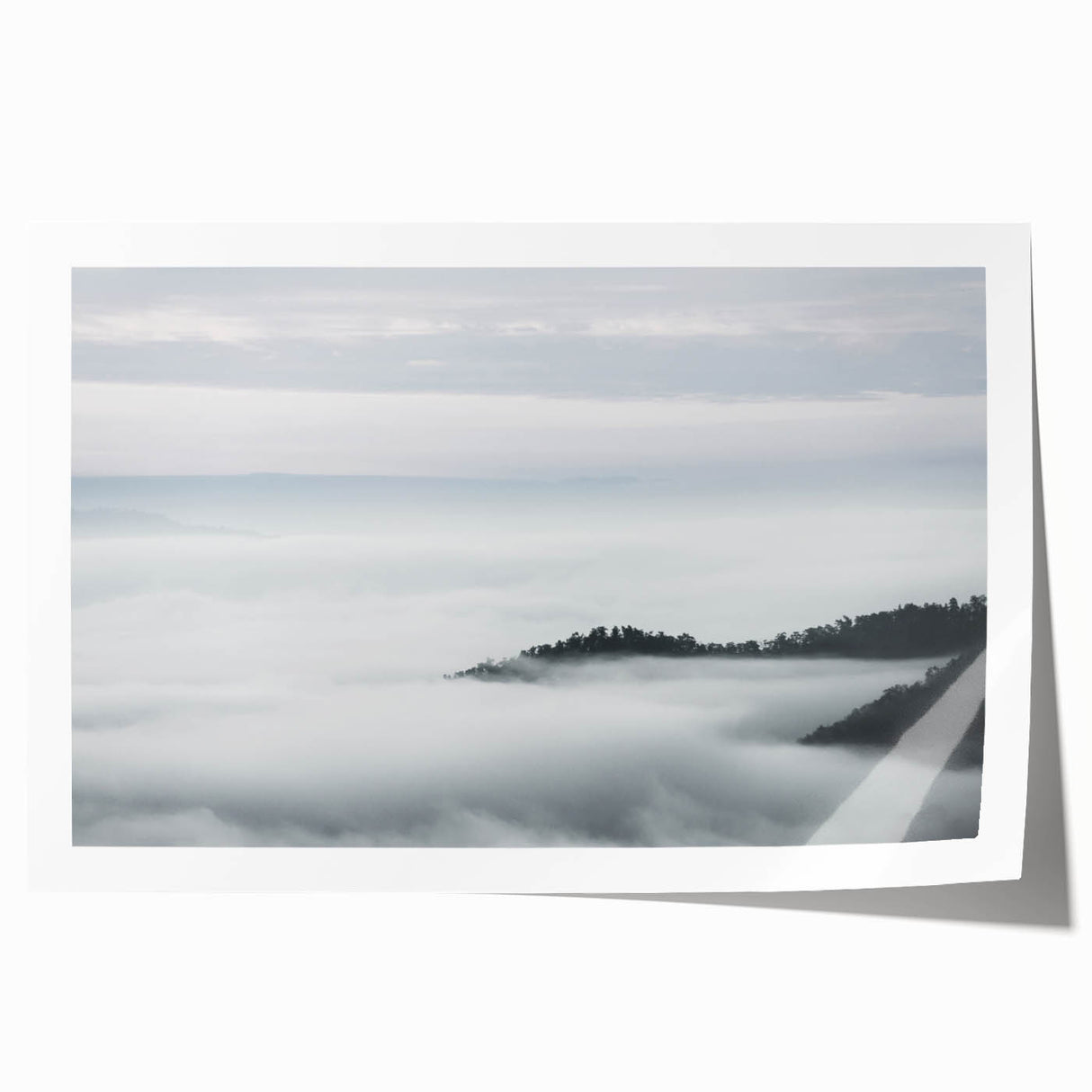 Serene landscape wall art print featuring ethereal mist and fog enveloping a forest scene, designed for home decor with calming, natural aesthetics.