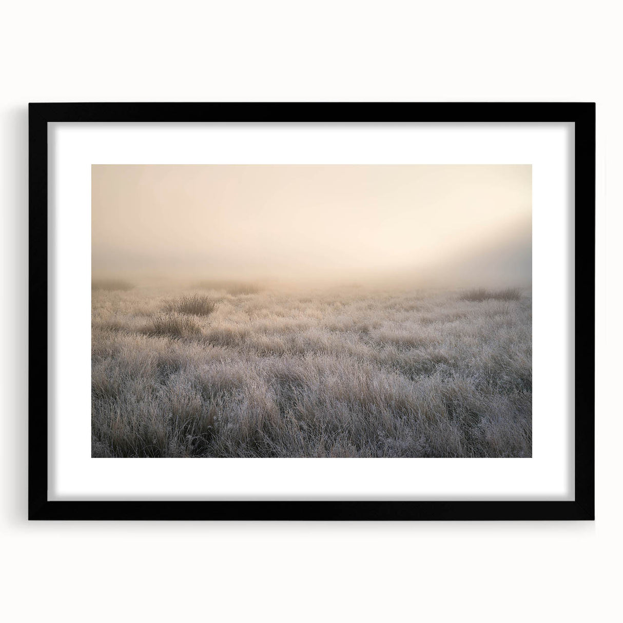 Framed landscape wall art featuring a serene misty forest scene, accented by a sleek black frame and mat, perfect for modern home decor.