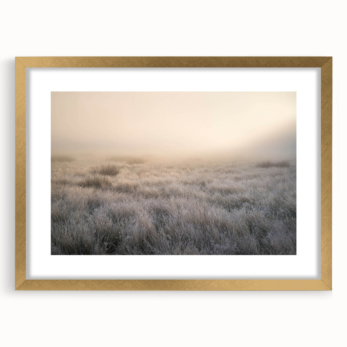 Framed wall art featuring a serene landscape design with mist and fog, accented by a gold frame, perfect for adding elegance to any room decor.
