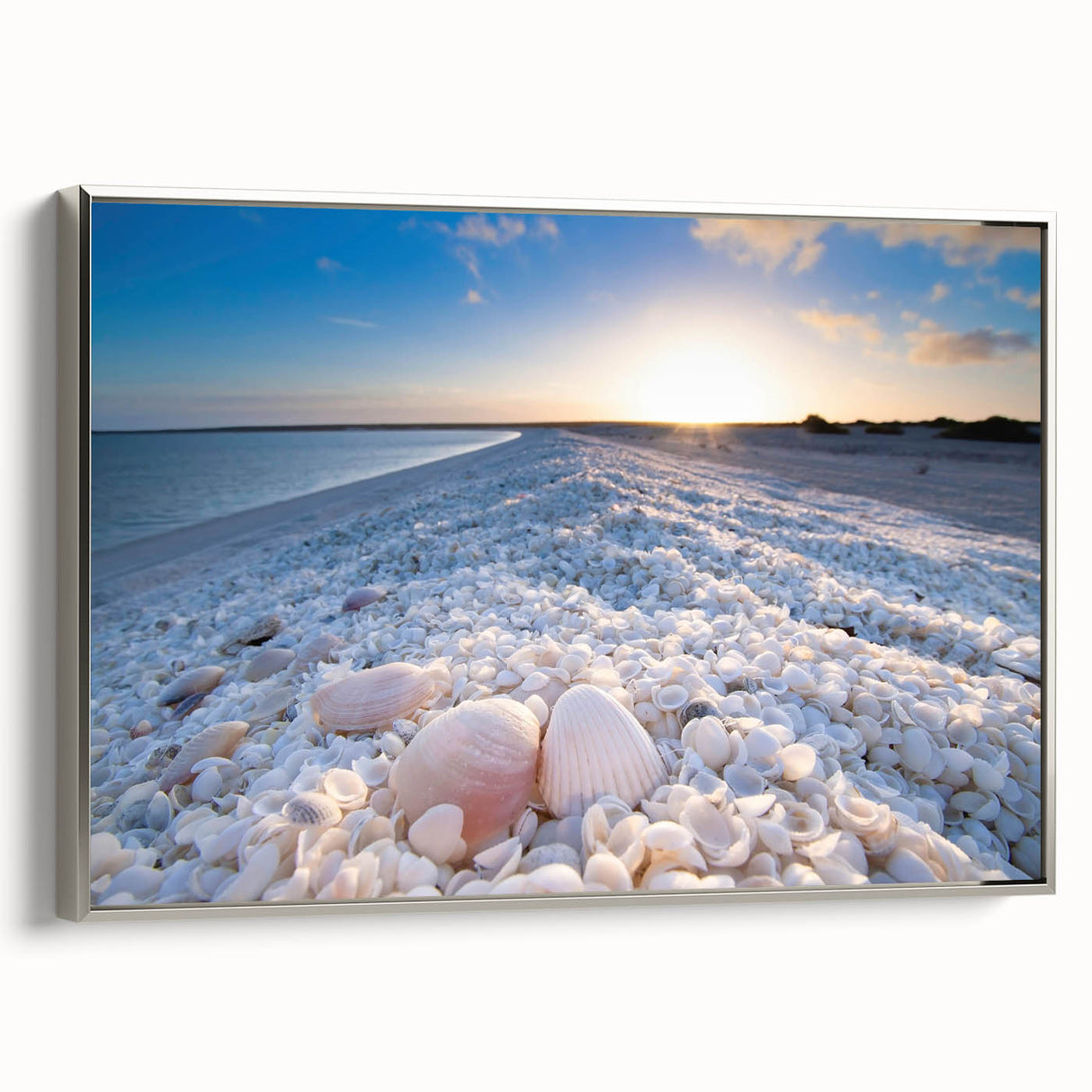 Framed canvas wall art from the Landscapes & Seascapes collection, showcasing a serene coastal scene with soft blues and greens, elegantly presented with a silver frame.
