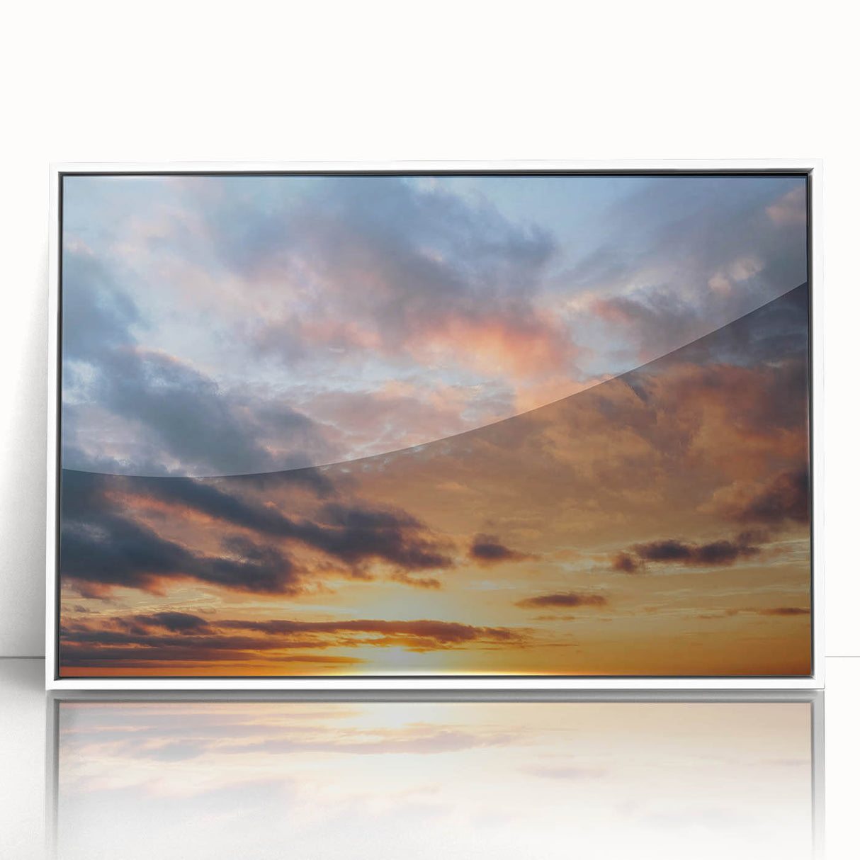 Framed acrylic wall art featuring a vibrant landscape design in a white frame, showcasing a picturesque skyscape with soft blues and warm sunset hues, perfect for home decor.