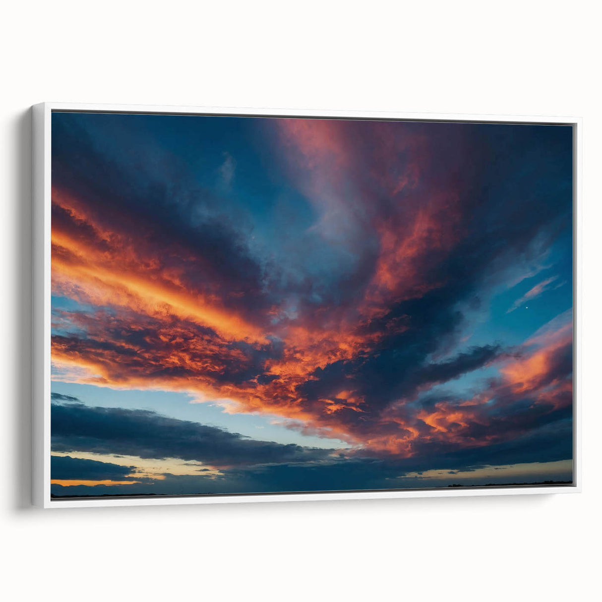 Framed canvas wall art from the Landscapes Skyscapes Design collection showcasing a serene sunset over mountains, featuring vibrant colors and a modern white frame, ideal for enhancing home decor.
