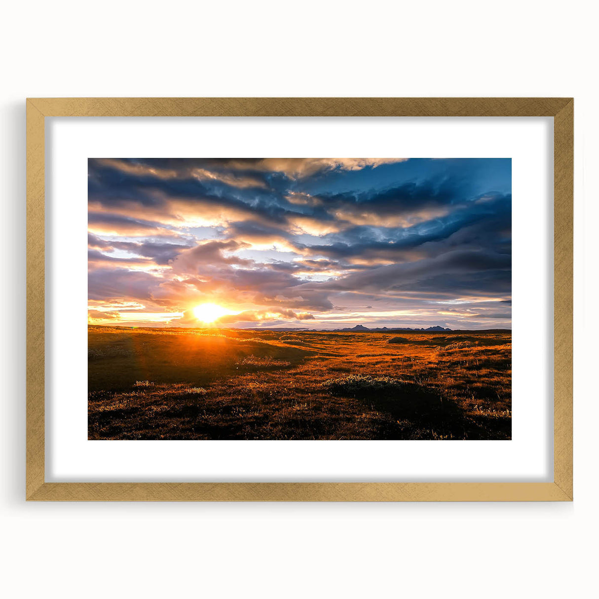 Gold-framed wall art showcasing a vibrant landscape and skyscape design, ideal for home decor, with a sleek mat enhancing its aesthetic appeal.