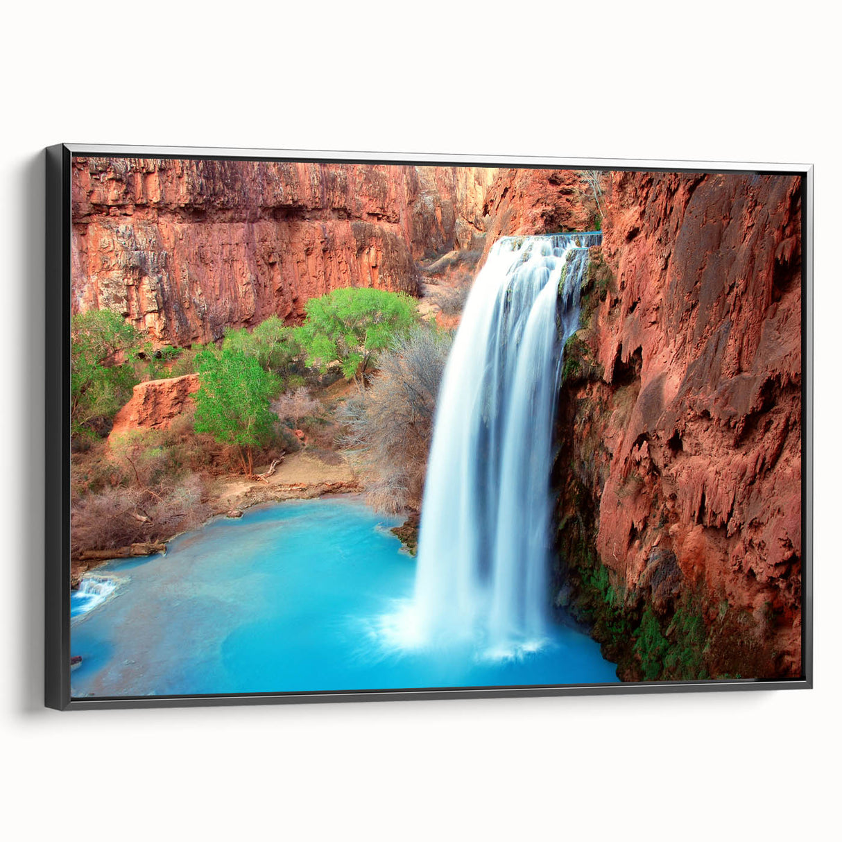 Framed canvas wall art showcasing a stunning waterfall landscape, featuring vibrant blue and green hues with a sleek black frame, perfect for home decor enhancement.