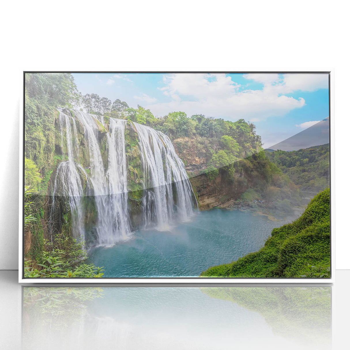 Framed acrylic wall art depicting a serene waterfall landscape with vibrant blue and green hues, perfect for enhancing home décor and creating a calming atmosphere.