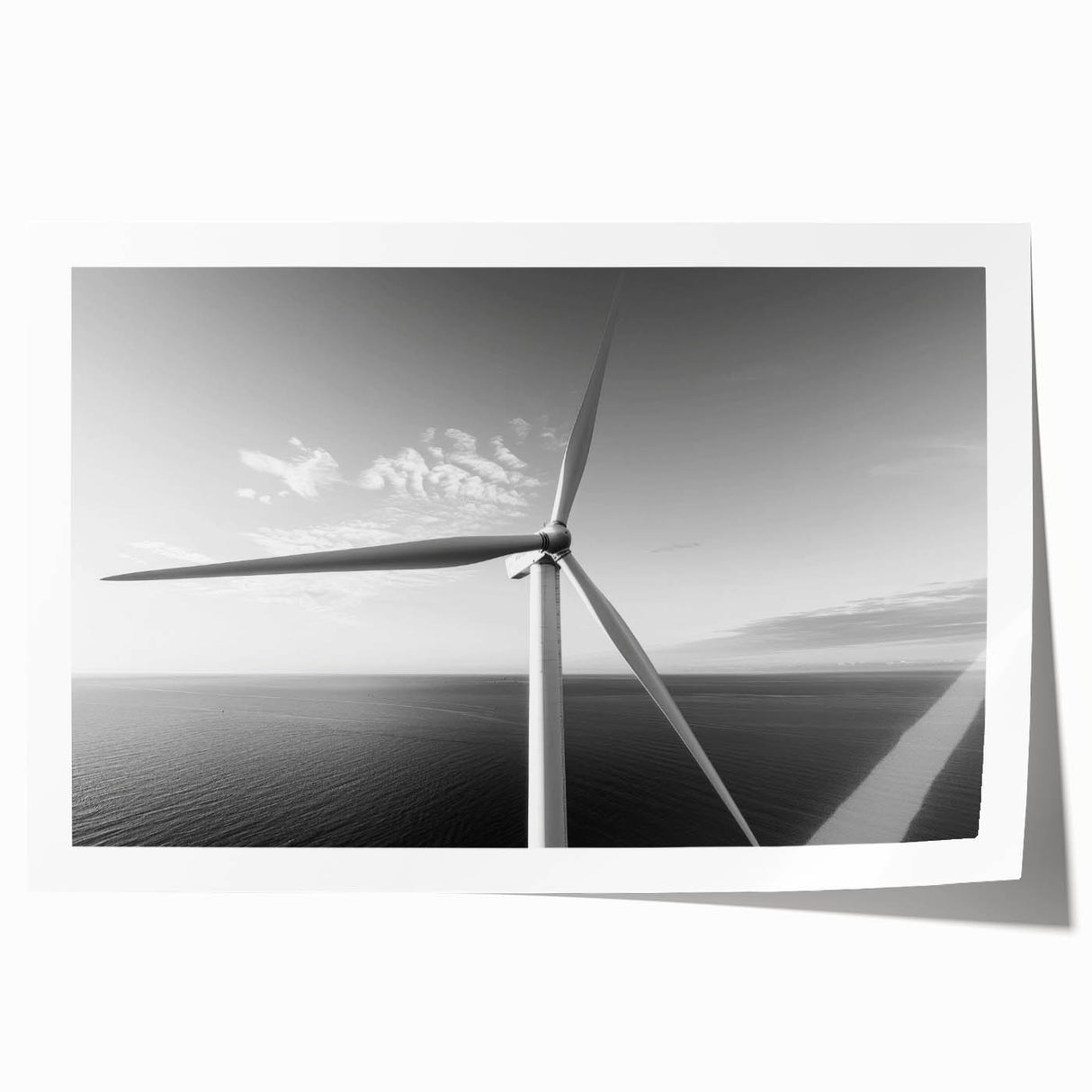 Rolled print showcasing a vibrant landscape with iconic windmills, perfect for home decor, featuring rich colors and intricate details, packaged securely in a cardboard tube.