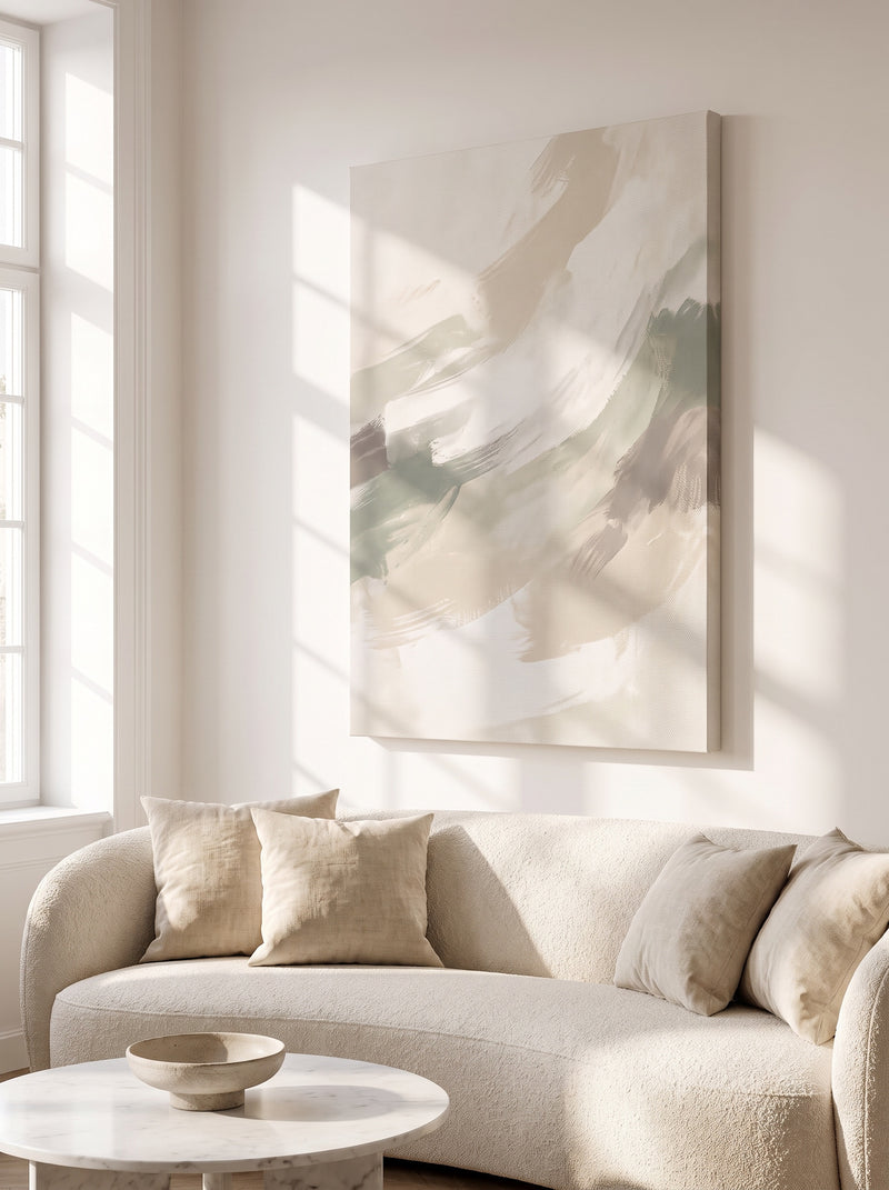 Custom canvas print of a soft sage and beige abstract above a curved bouclé sofa in a sunlit living room