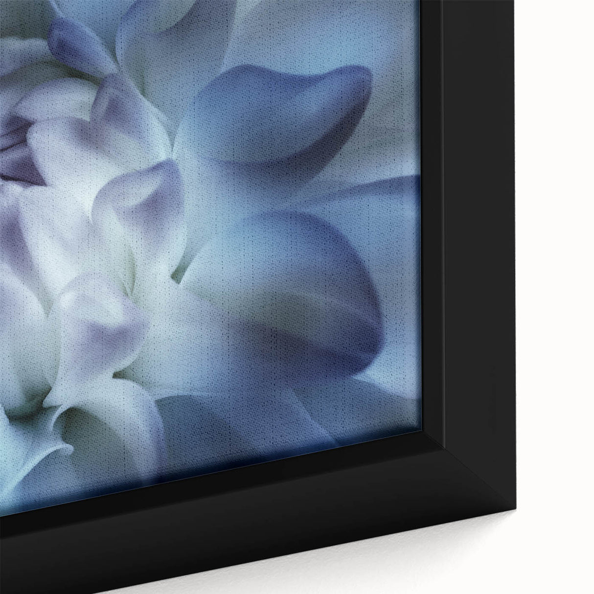 Close-up of a black framed canvas featuring a textured floral design with vibrant colors, ideal for living room decor.