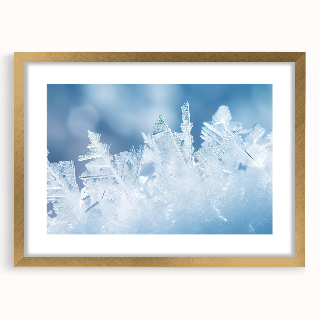 Textured art print of abstract frost patterns in muted white and gray, framed in gold, ideal for bedroom art.