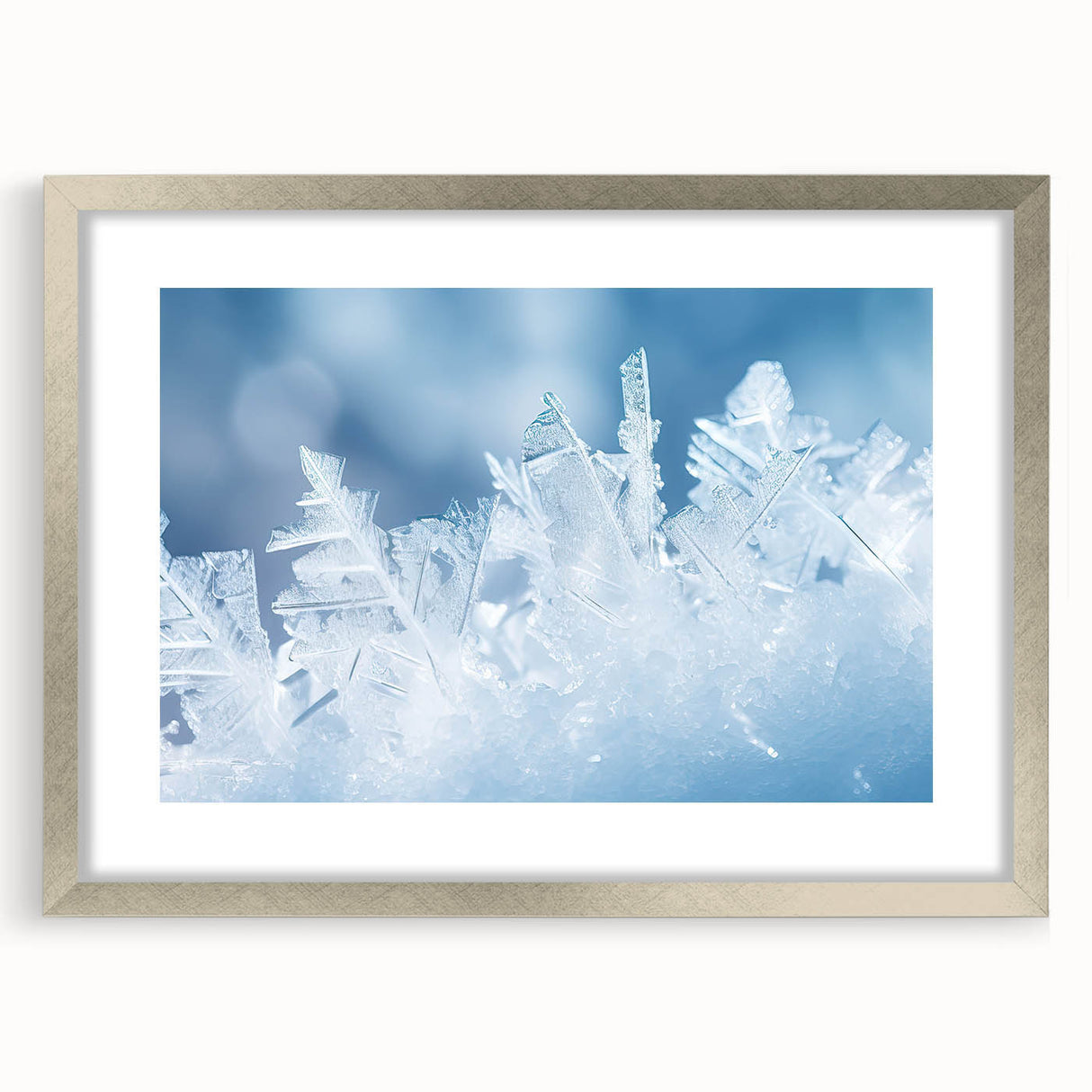 Abstract art print featuring close-up frost patterns in gray and white tones, framed in silver.