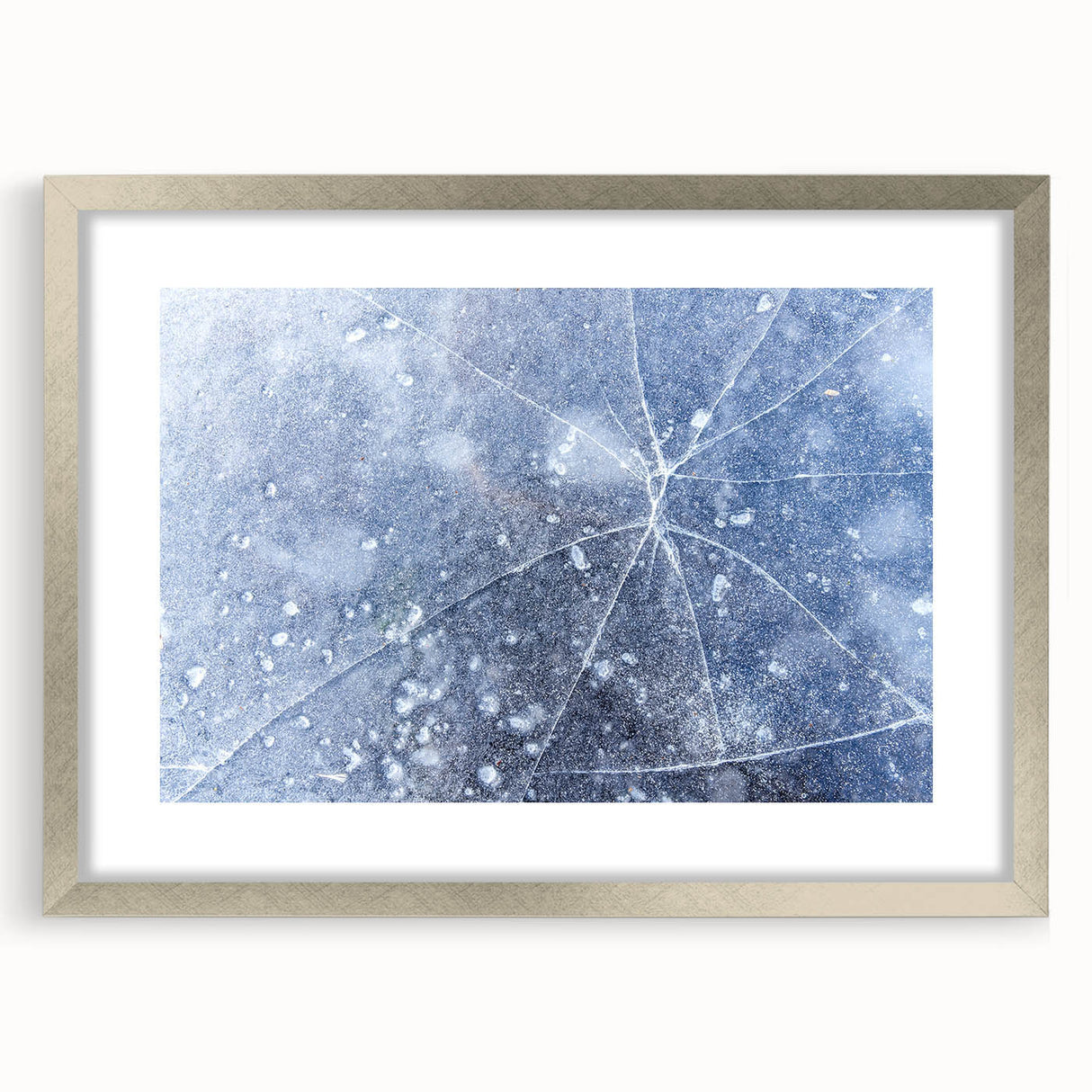 Abstract art print featuring a close-up frost design in muted blue and white tones, framed with a silver mat.