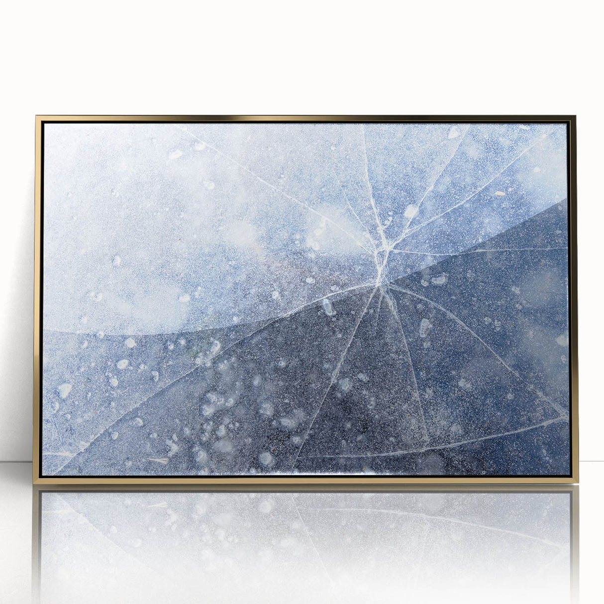 Mid-century modernist art depicting a close-up of frost patterns in muted gray and blue, acrylic print in a gold frame.