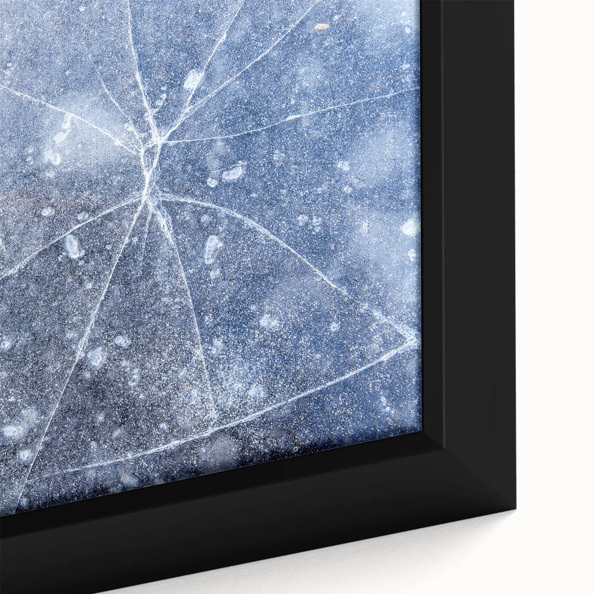 Close-up of textured black wall art depicting ice formations in vibrant blues and whites on a large framed canvas.