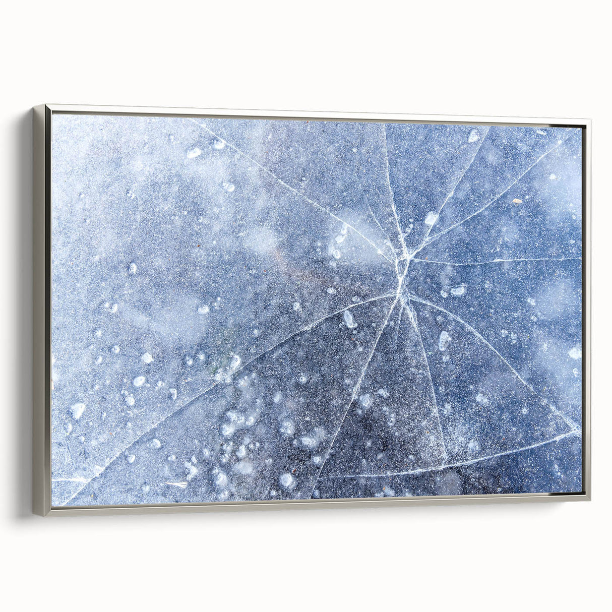 Framed canvas depicting a close-up of frost patterns in muted silver and gray tones, ideal for living room decor.