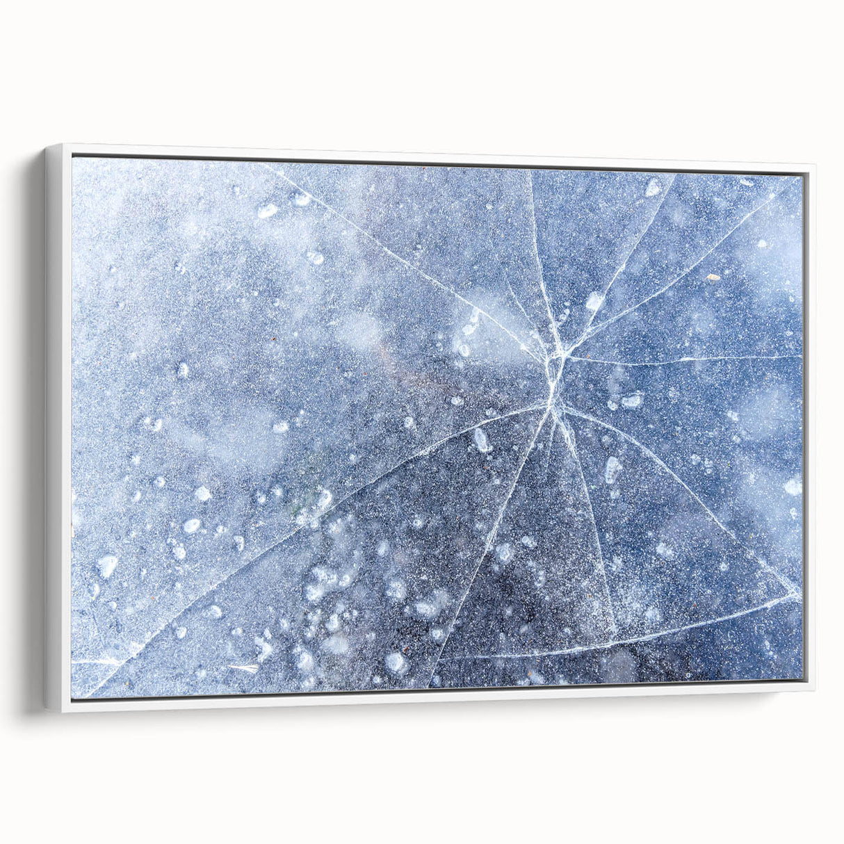 Framed canvas featuring a close-up of frost patterns in muted gray and white tones, suitable as wall art for a bedroom.