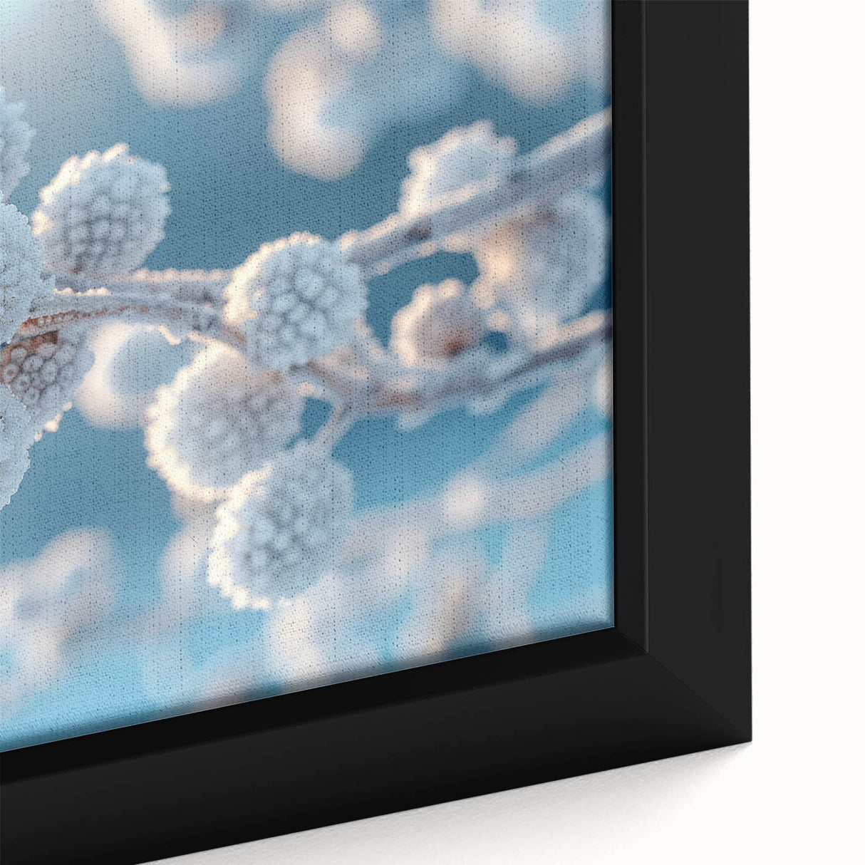 Close-up of textured black wall art depicting frost designs in vibrant colors on a framed canvas.