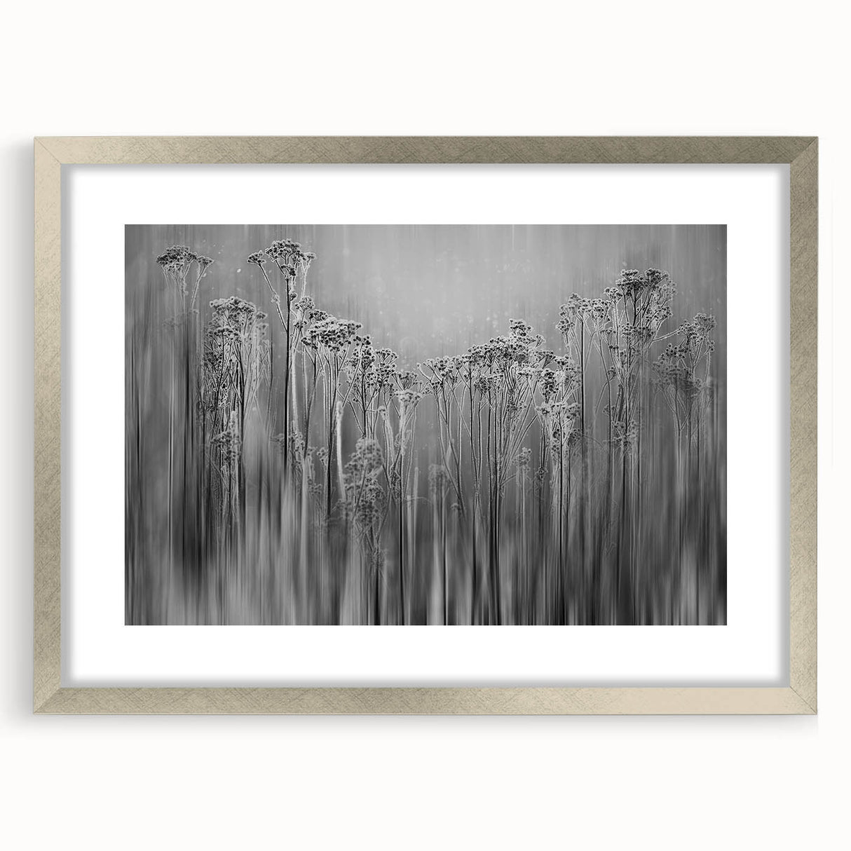 Abstract art print featuring a close-up of frost patterns in muted silver and gray tones, framed in silver.