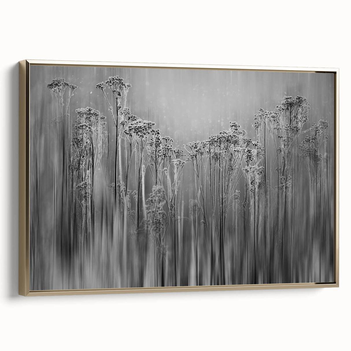 Framed canvas depicting a close-up landscape of frost patterns in muted gray and blue tones.