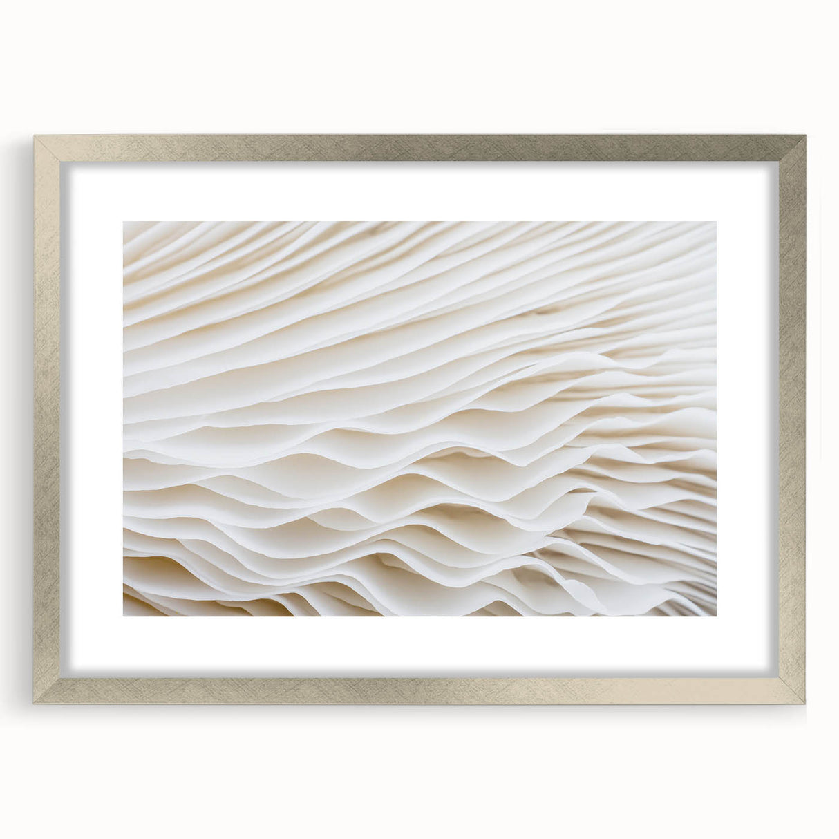 Textured art print of abstract leaves in silver frame, using muted green and brown tones, ideal for bedroom wall decor.