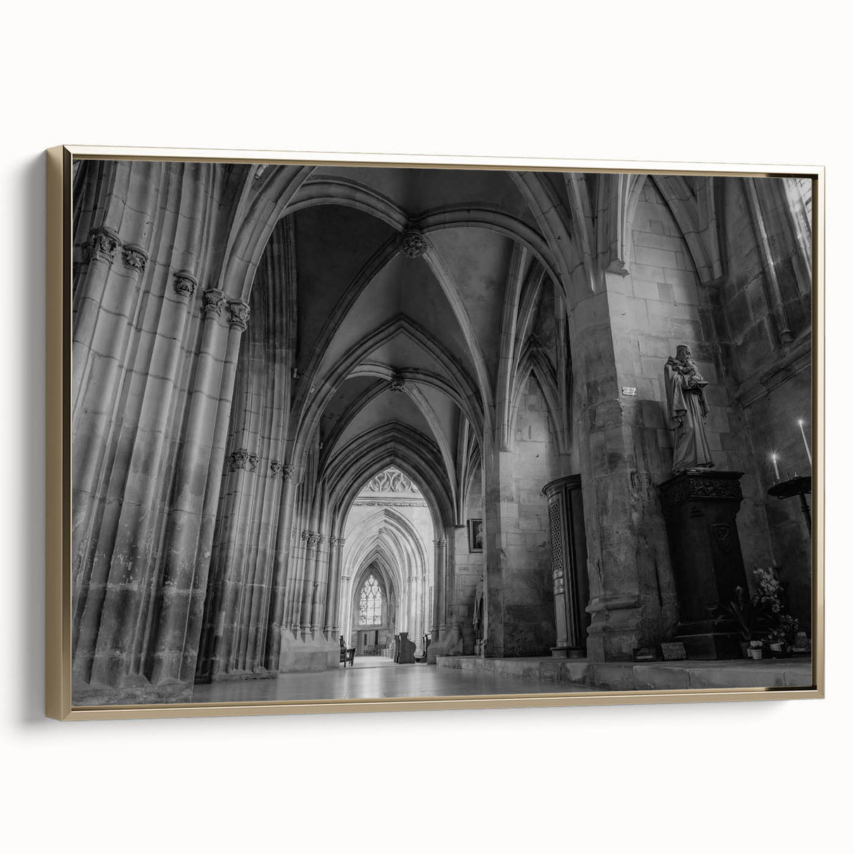 Framed canvas of a vintage landscape painting featuring a church, rendered in muted gold and black tones.