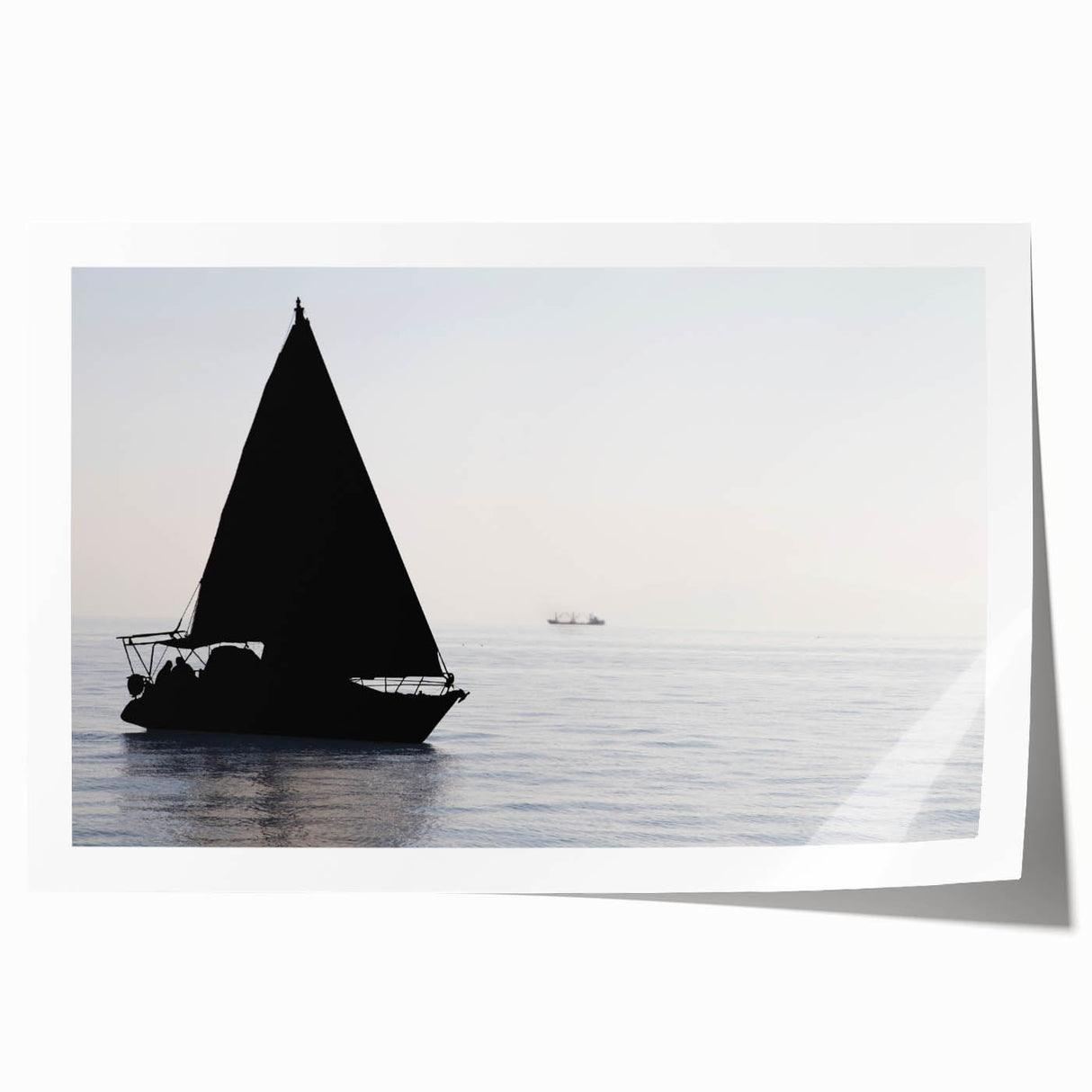 Sailboat on calm waters in muted blue and white hues on a rolled canvas, ideal for dining room wall art.