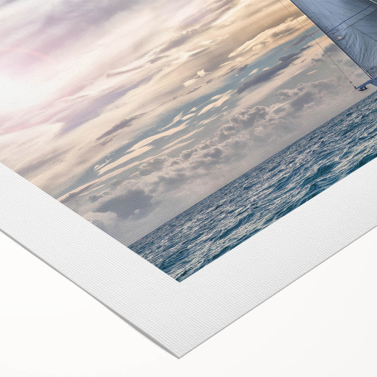 Art deco poster of a sailboat on a rolled canvas, featuring soft blue and white hues, ideal for dining room wall decor.