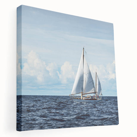 Sailboat on a calm sea depicted in muted blue and white tones on a stretched canvas, suitable for kitchen wall art.