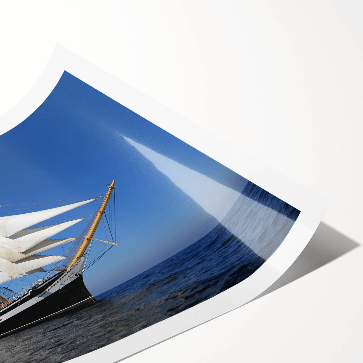 Extra large wall art of a ship at sea, depicted in muted blue tones on rolled canvas, suitable for large living room decor.