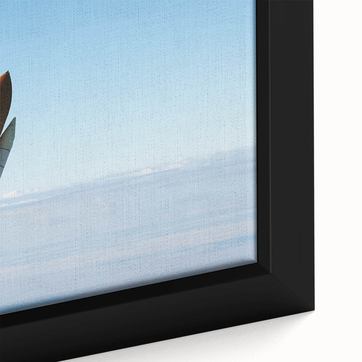 Close-up of a framed canvas featuring a black background with a colorful, textured depiction of a spacecraft.