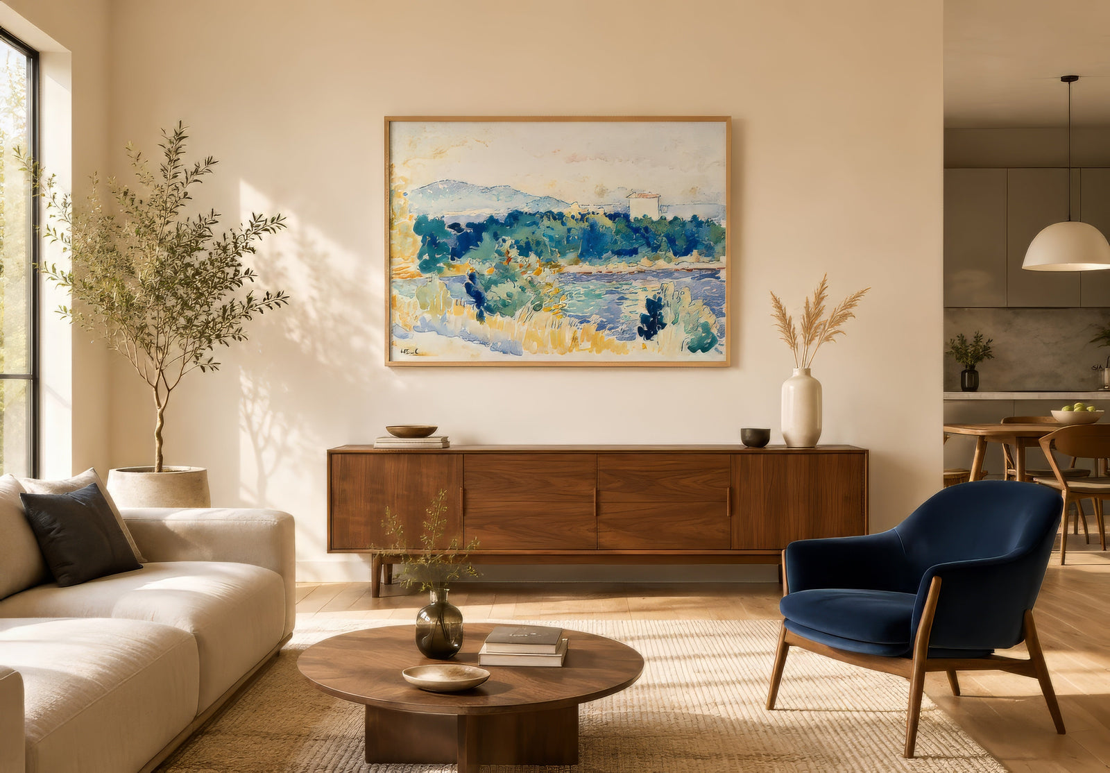 Impressionist coastal hillside landscape in navy, green, and gold, framed above a walnut sideboard in a modern open-concept living room.