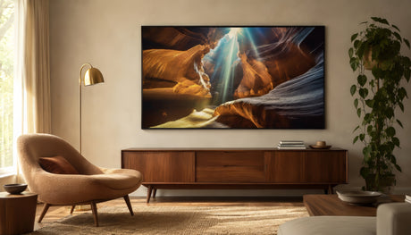 Dramatic slot canyon canvas in amber and copper tones above an oak credenza in an airy modern living room.