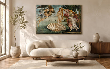 Botticelli Birth of Venus canvas in rose and gold above a boucle sofa in an airy contemporary living room.