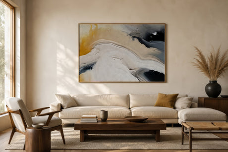 Minimal abstract canvas in ivory, gold, and black, oak-framed above an oatmeal sofa in a calm Scandinavian living room.