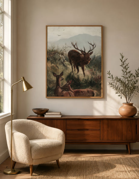 Antique-style wildlife oil painting of a stag and deer in brown and green, framed in oak above a walnut credenza in a warm minimalist living room.