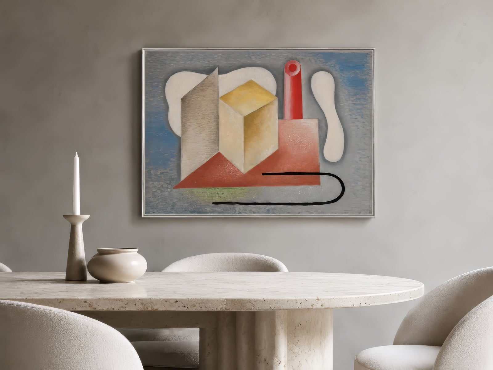 Contemporary cubist abstract canvas with cream cube, red and gray forms, framed above a travertine dining table in a warm minimalist room